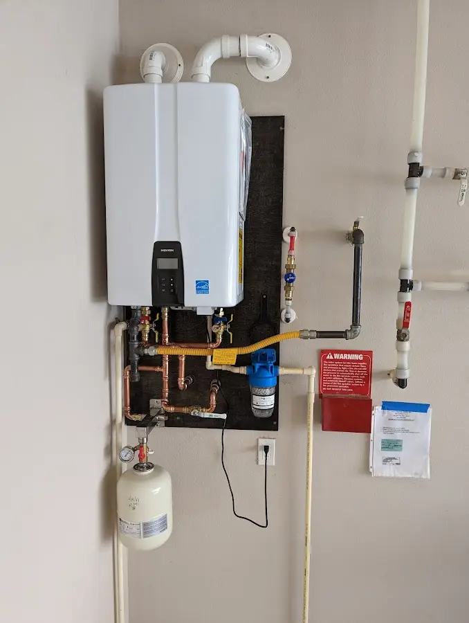 Professional plumber installing copper piping in a Orland Park home